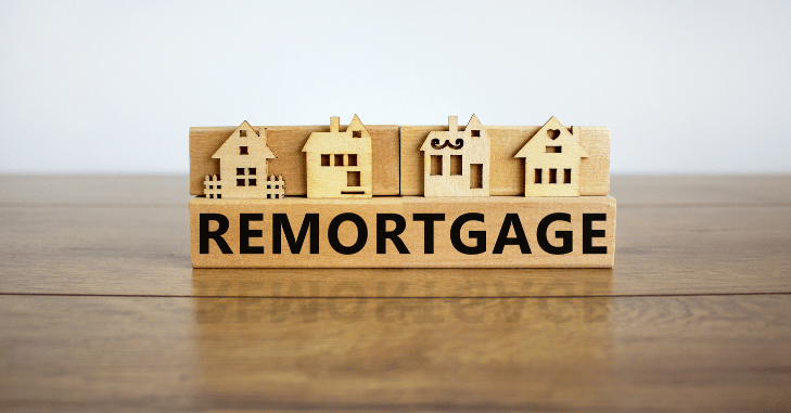 Homeowner comparing UK remortgage rates and lender fees on a laptop