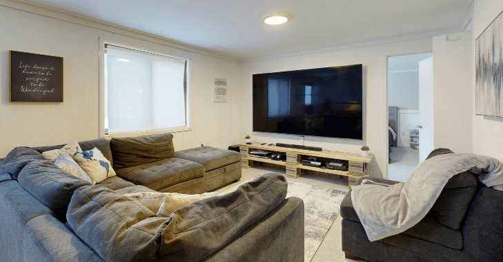 Television concealed within a fitted alcove cabinet