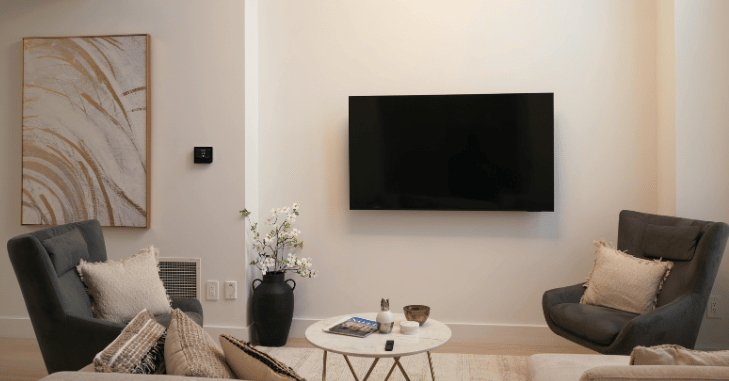 Floating shelves framing a television in a narrow lounge