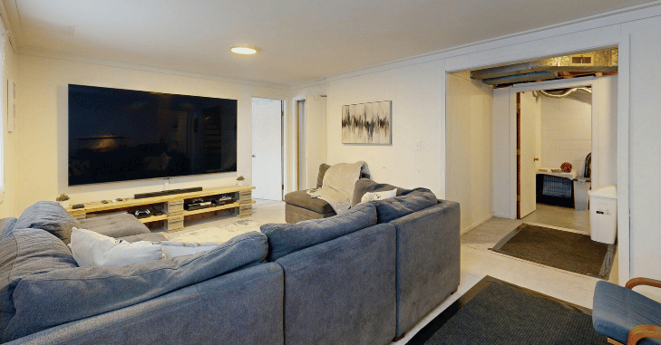 Compact living room with a wall-mounted television above a slim console