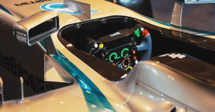 Early motorsport steering wheel compared with a modern design