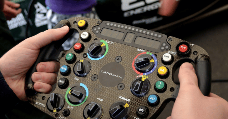 Engineer adjusting settings on a racing car wheel